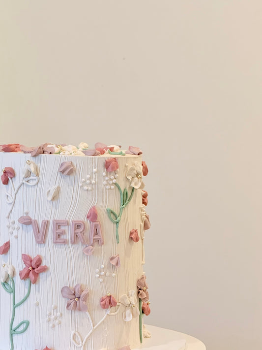 Vera floral cake side view with soft buttercream blooms — Bakeology Studios Melbourne
