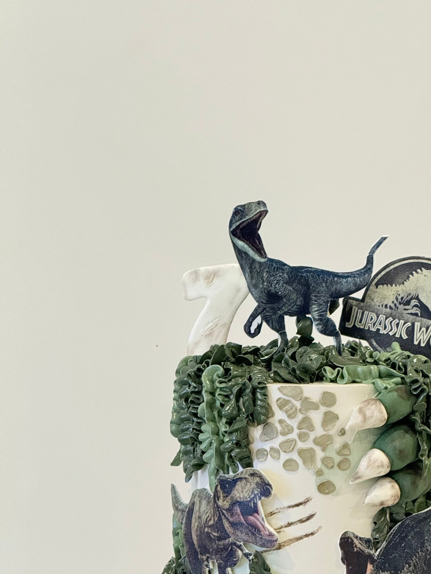 Blue Jurassic World themed celebration cake with number topper — custom kids cake Melbourne by Bakeology Studios