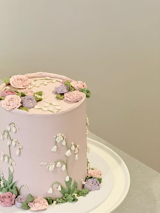 Evelyn floral cake top view — lush rose arrangement on soft pink buttercream — Bakeology Studios Melbourne