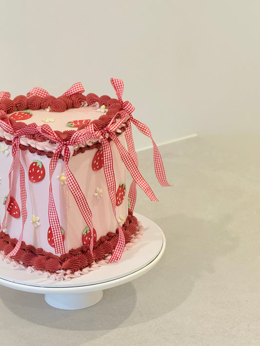 Lottie vintage cake top view — gingham ribbons and strawberry details — Bakeology Studios Melbourne