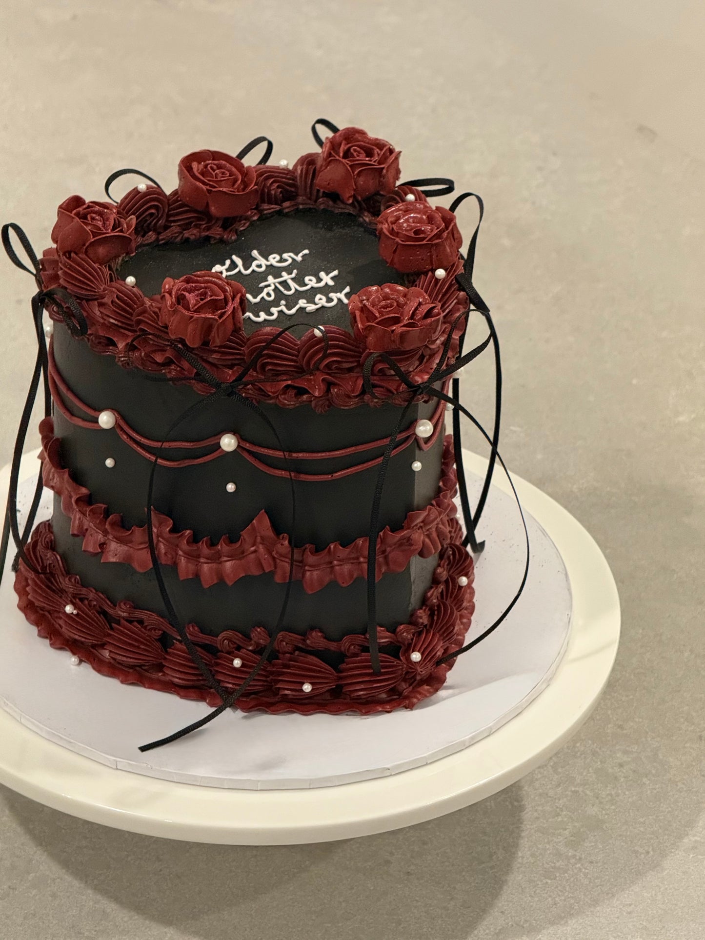 Colette black celebration cake with deep burgundy roses — Bakeology Studios Melbourne