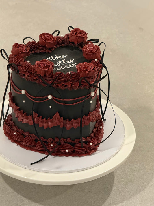 Colette black celebration cake with deep burgundy roses — Bakeology Studios Melbourne