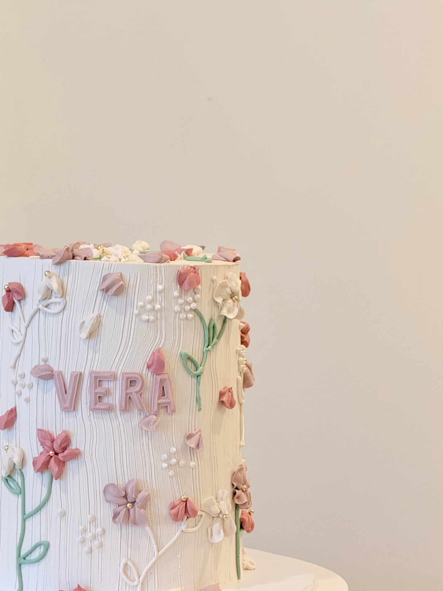 Vera floral cake side view with soft buttercream blooms — Bakeology Studios Melbourne