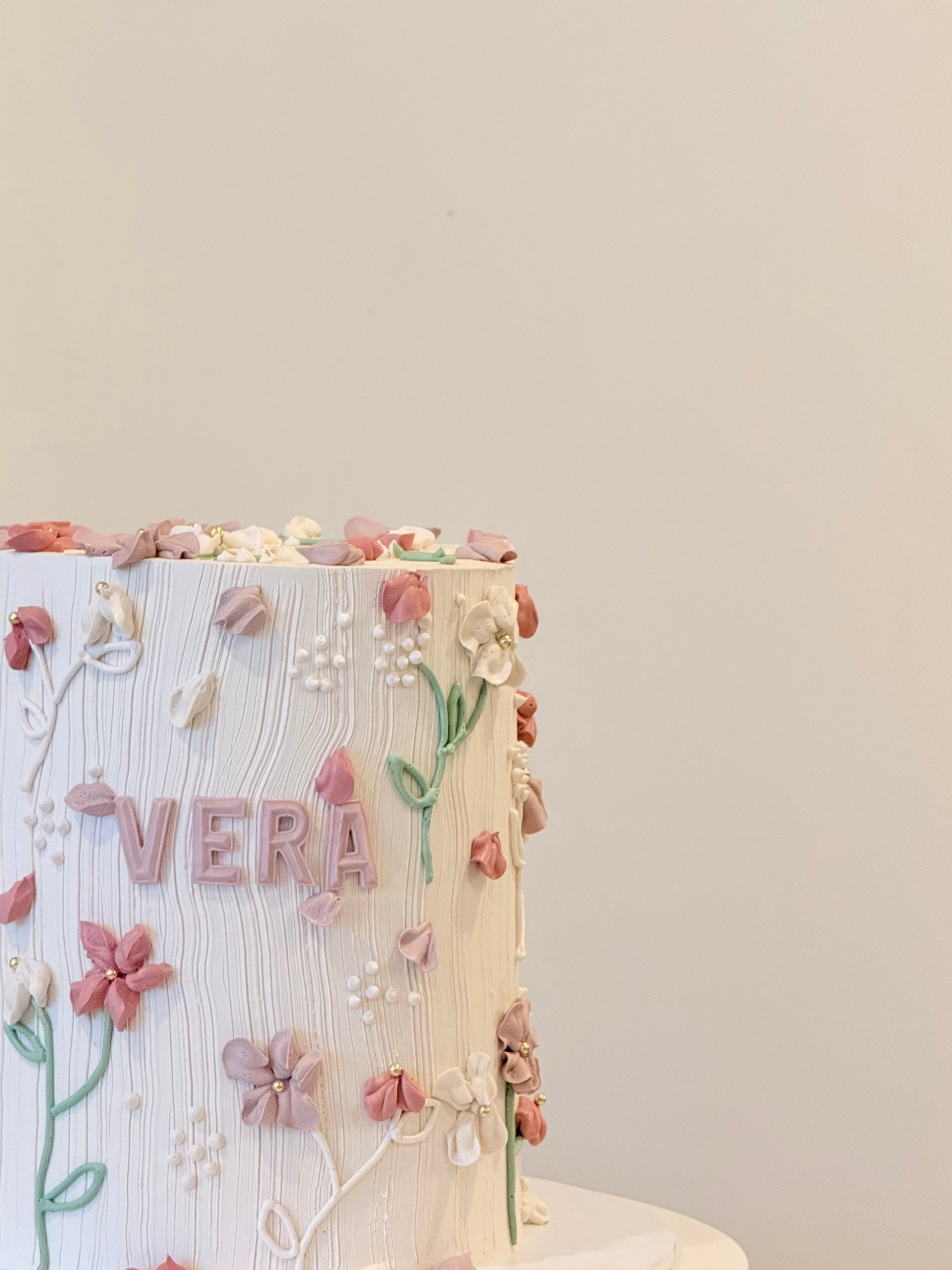 Vera floral cake side view with soft buttercream blooms — Bakeology Studios Melbourne
