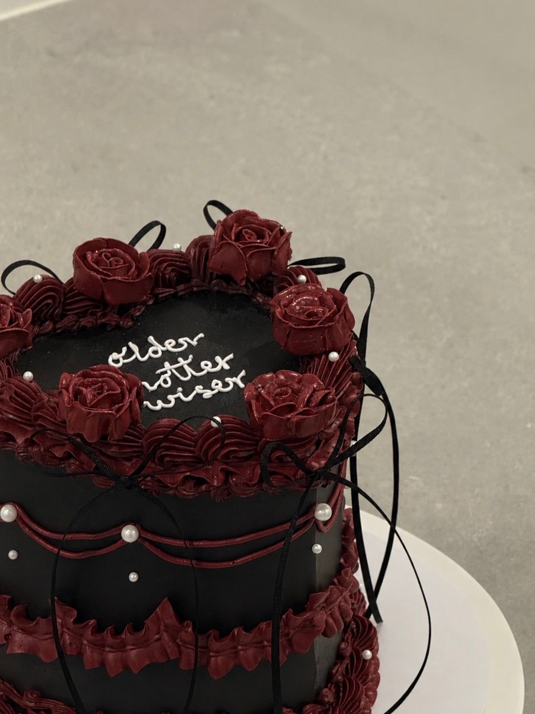 Colette close-up — hand-piped burgundy roses on black buttercream, handcrafted in Burwood East Melbourne