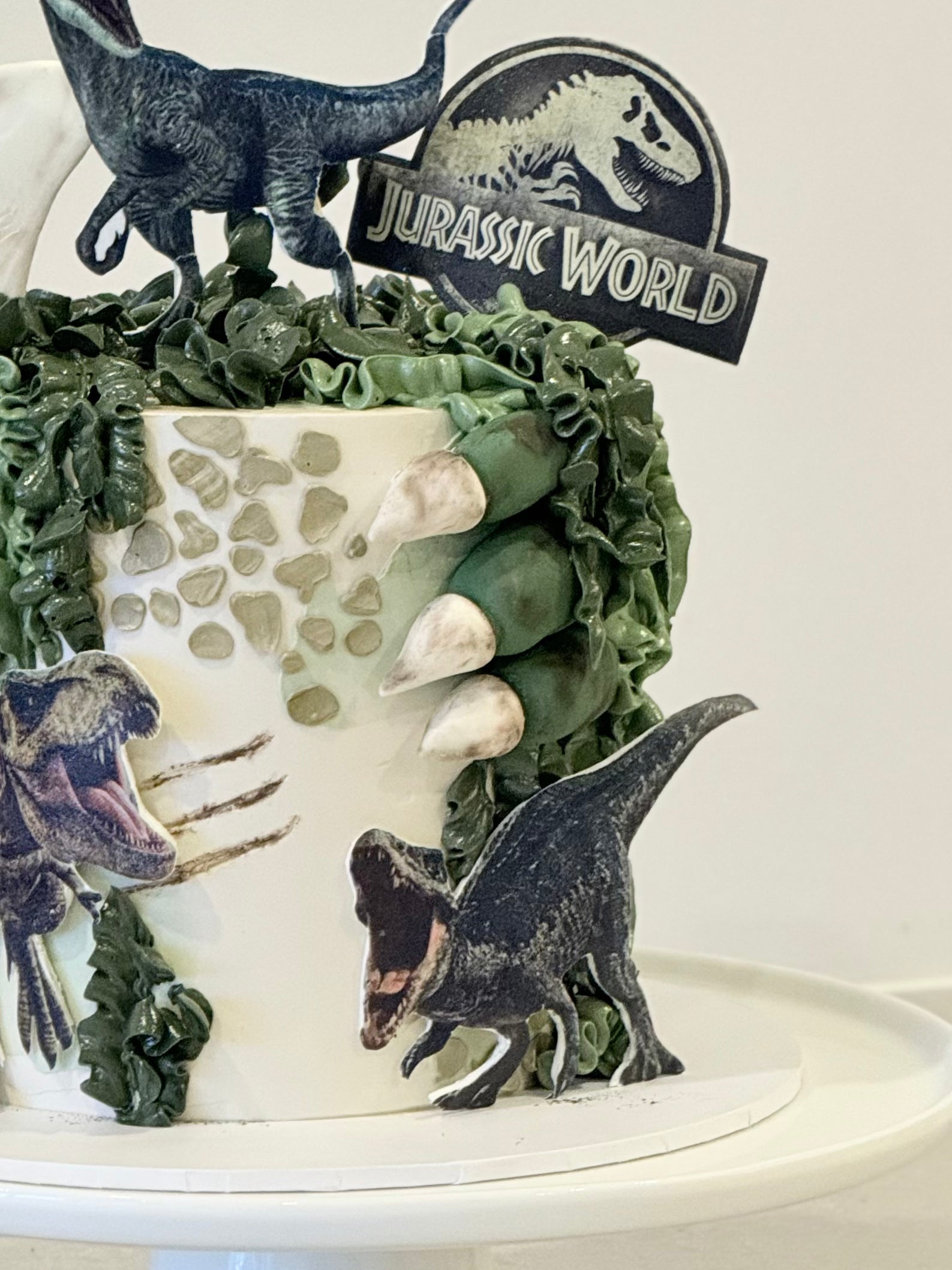 Blue dinosaur birthday cake close-up — Jurassic World themed handcrafted cake Bakeology Studios Burwood East