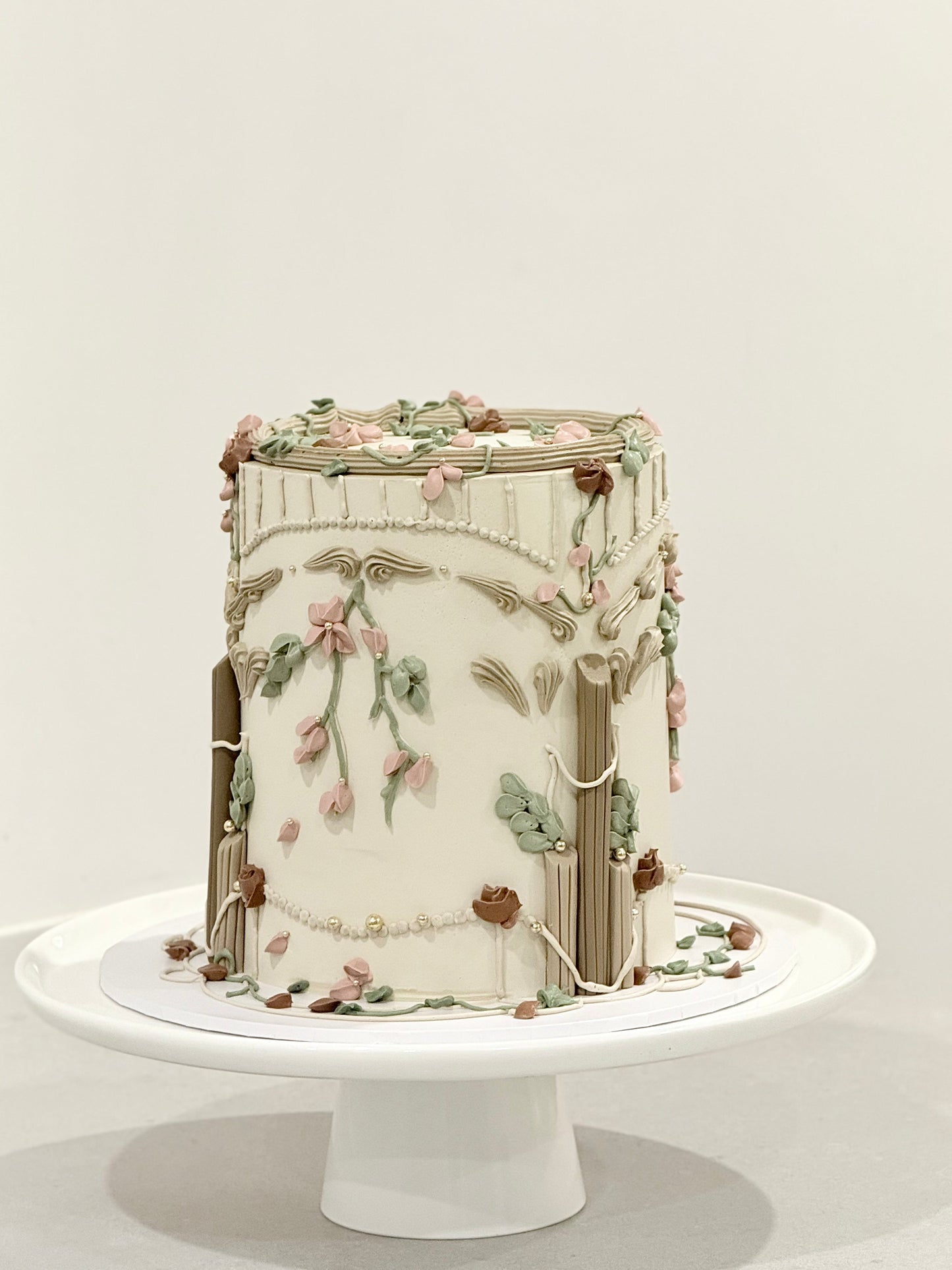 Cleo side detail — hand-piped florals and sage leaves on vintage celebration cake Melbourne Bakeology Studios