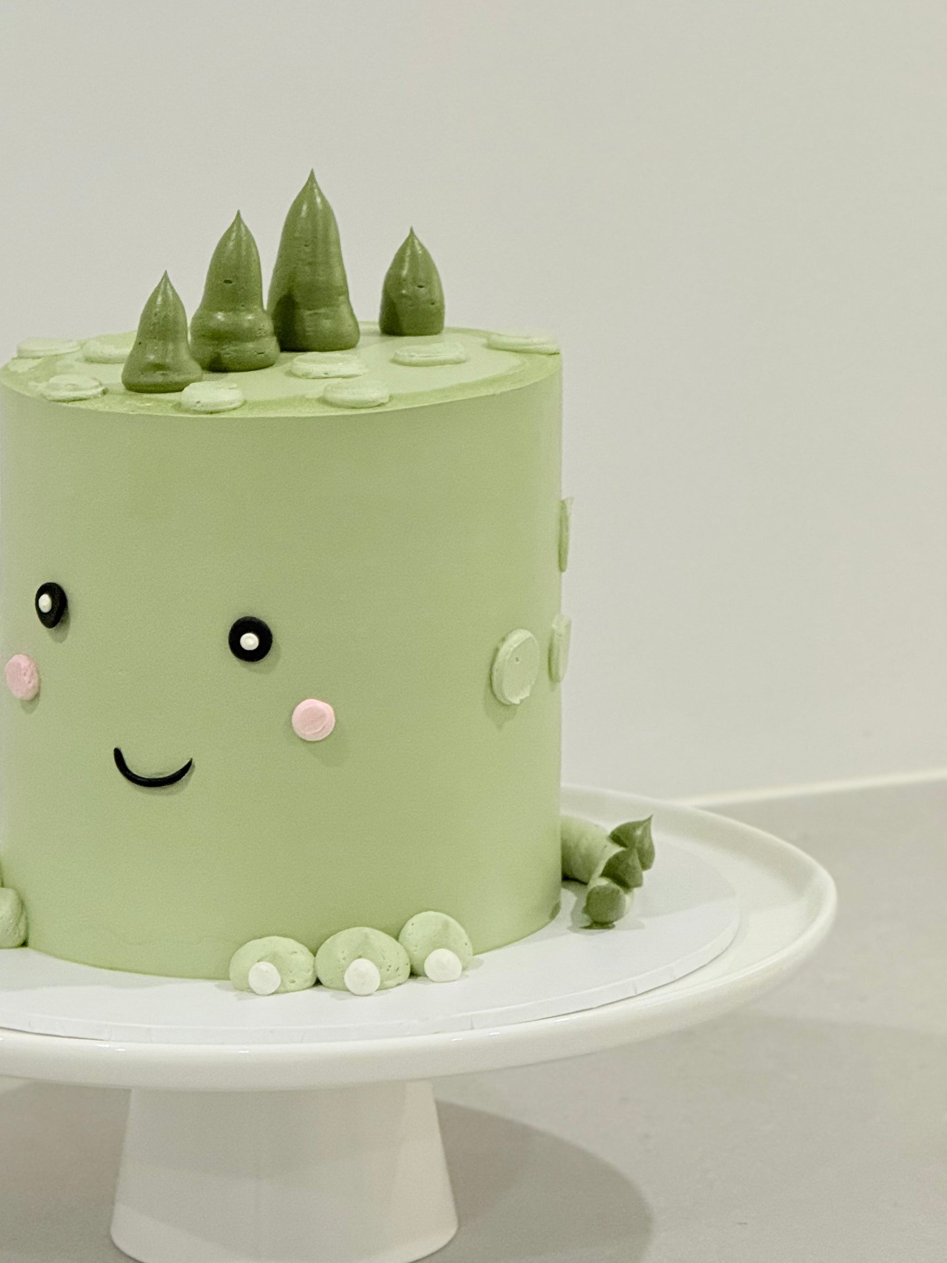Kawaii kids birthday cake side detail — sage green buttercream and pearl details Melbourne Bakeology Studios