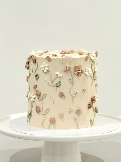 Elodie close-up — hand-sculpted 3D terracotta and white florals on textured buttercream — Bakeology Studios Burwood East
