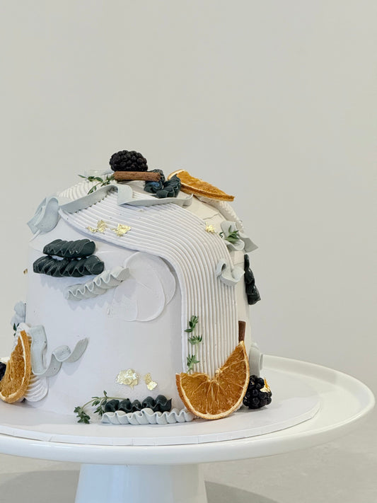 Elowen top angle — luxury botanical celebration cake with dark tassels and citrus — Bakeology Studios Melbourne