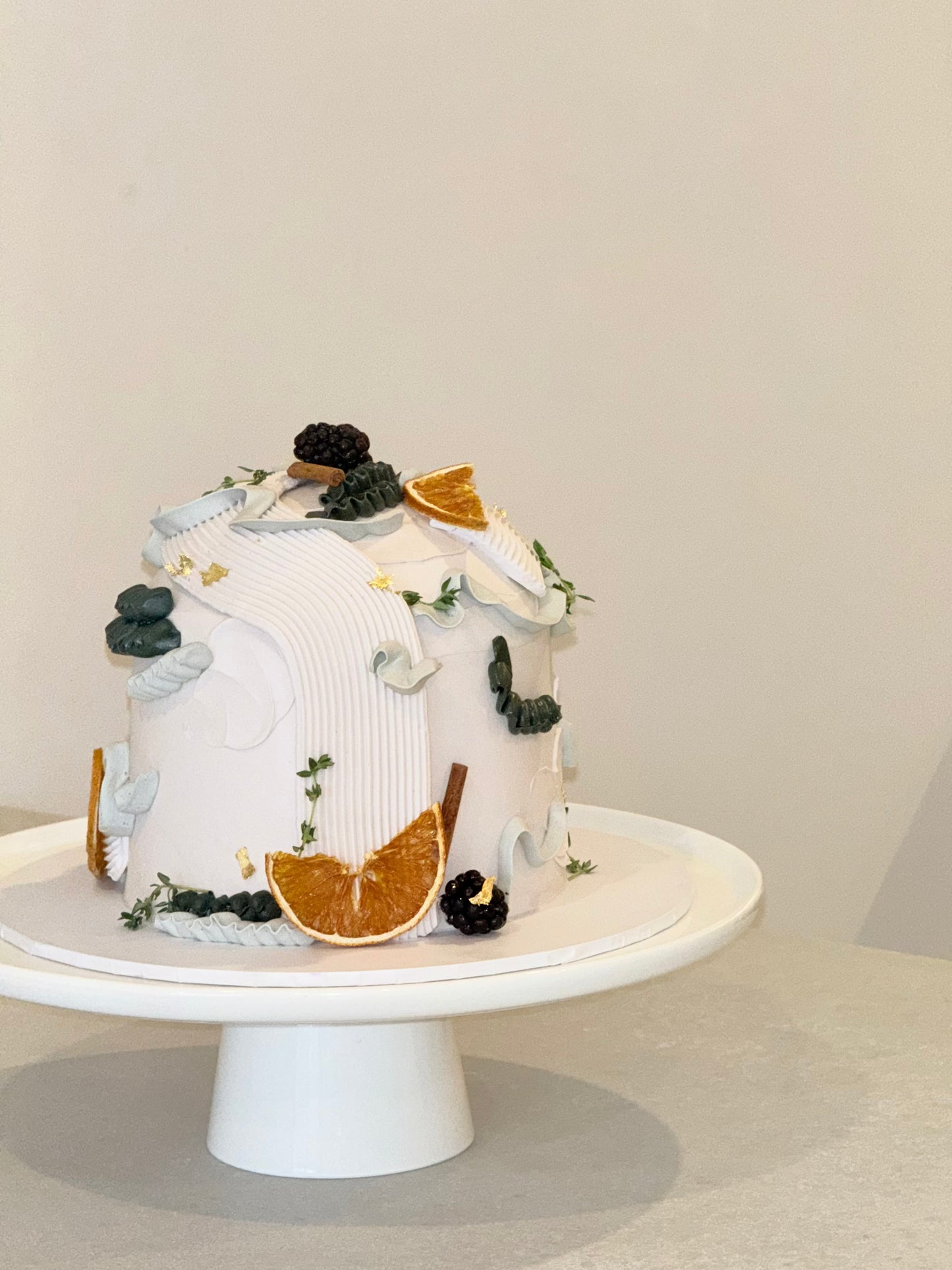 Elowen close-up detail — ribbed buttercream luxury cake with gold leaf and botanicals — Bakeology Studios Burwood East