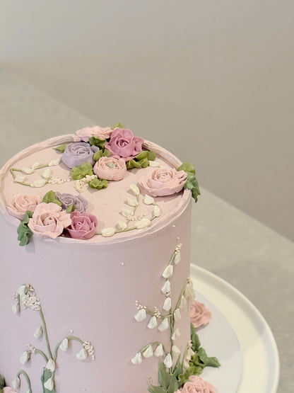 Evelyn romantic lilac floral celebration cake with scattered roses — custom handcrafted Melbourne Bakeology Studios