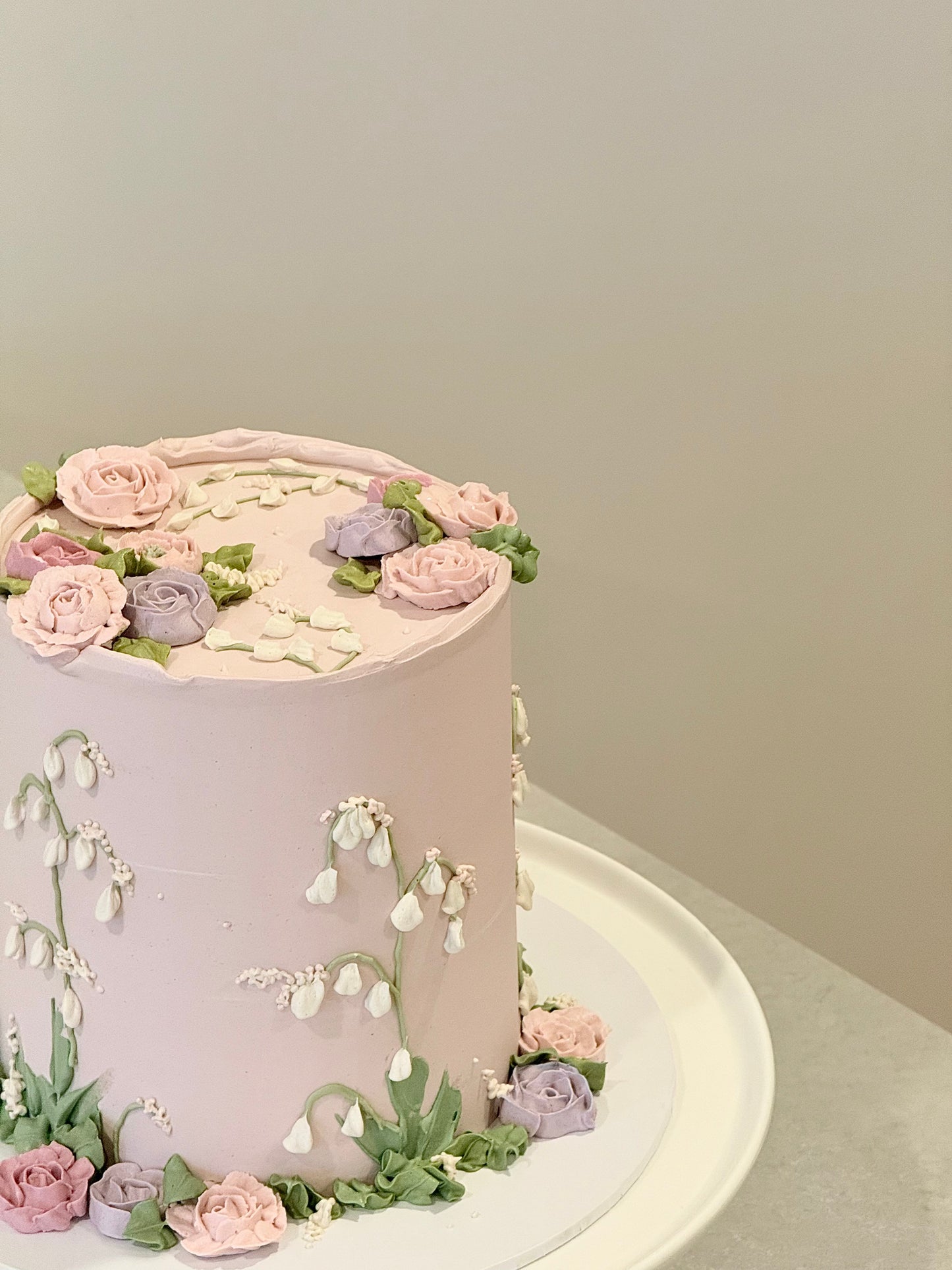 Evelyn floral cake top view — lush rose arrangement on soft pink buttercream — Bakeology Studios Melbourne