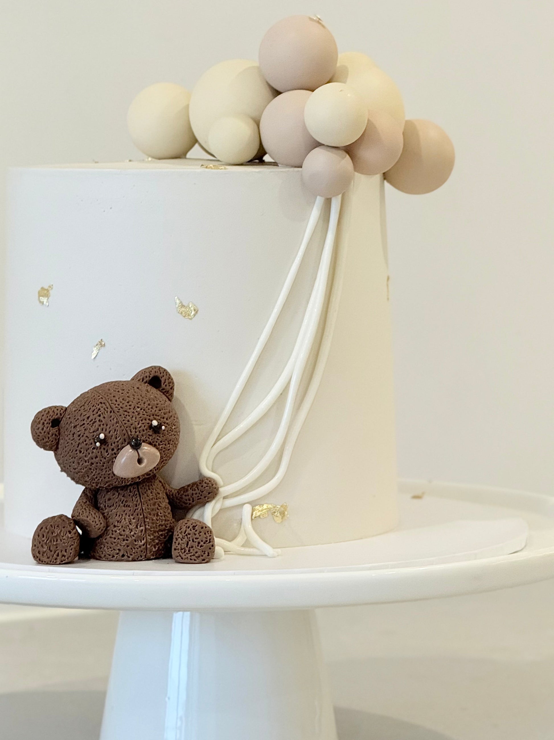 Finn kids birthday cake top view — organic balloon spheres and gold star details — Bakeology Studios Melbourne