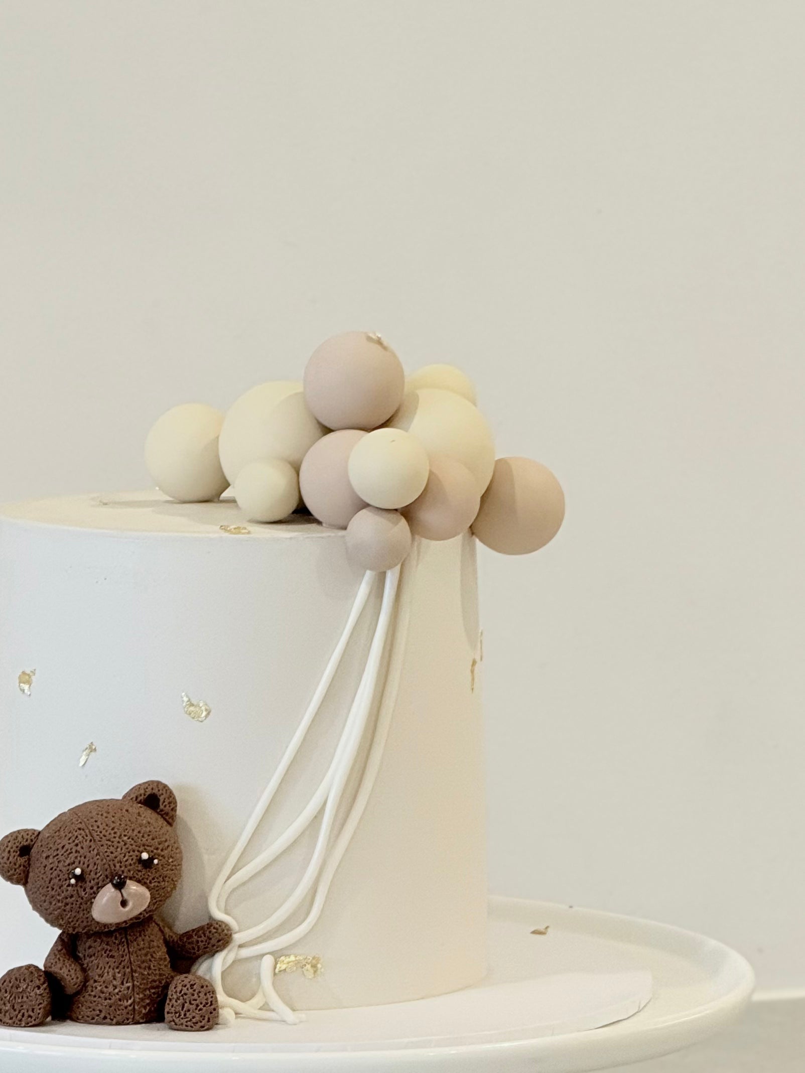 Finn dreamy ivory balloon birthday cake with teddy bear topper — custom kids cake Melbourne by Bakeology Studios