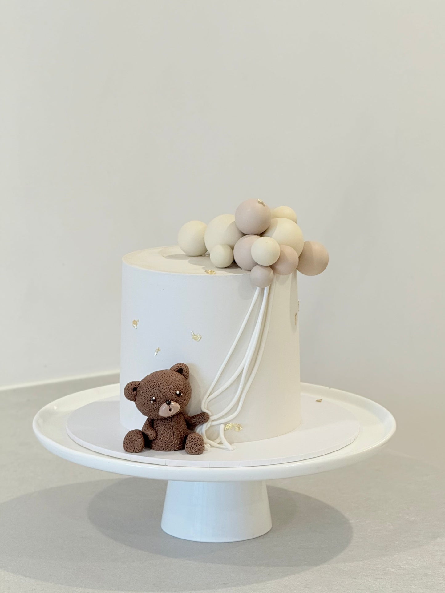 Finn teddy bear balloon kids birthday cake — cream buttercream with sculpted bear figurine Melbourne Bakeology Studios