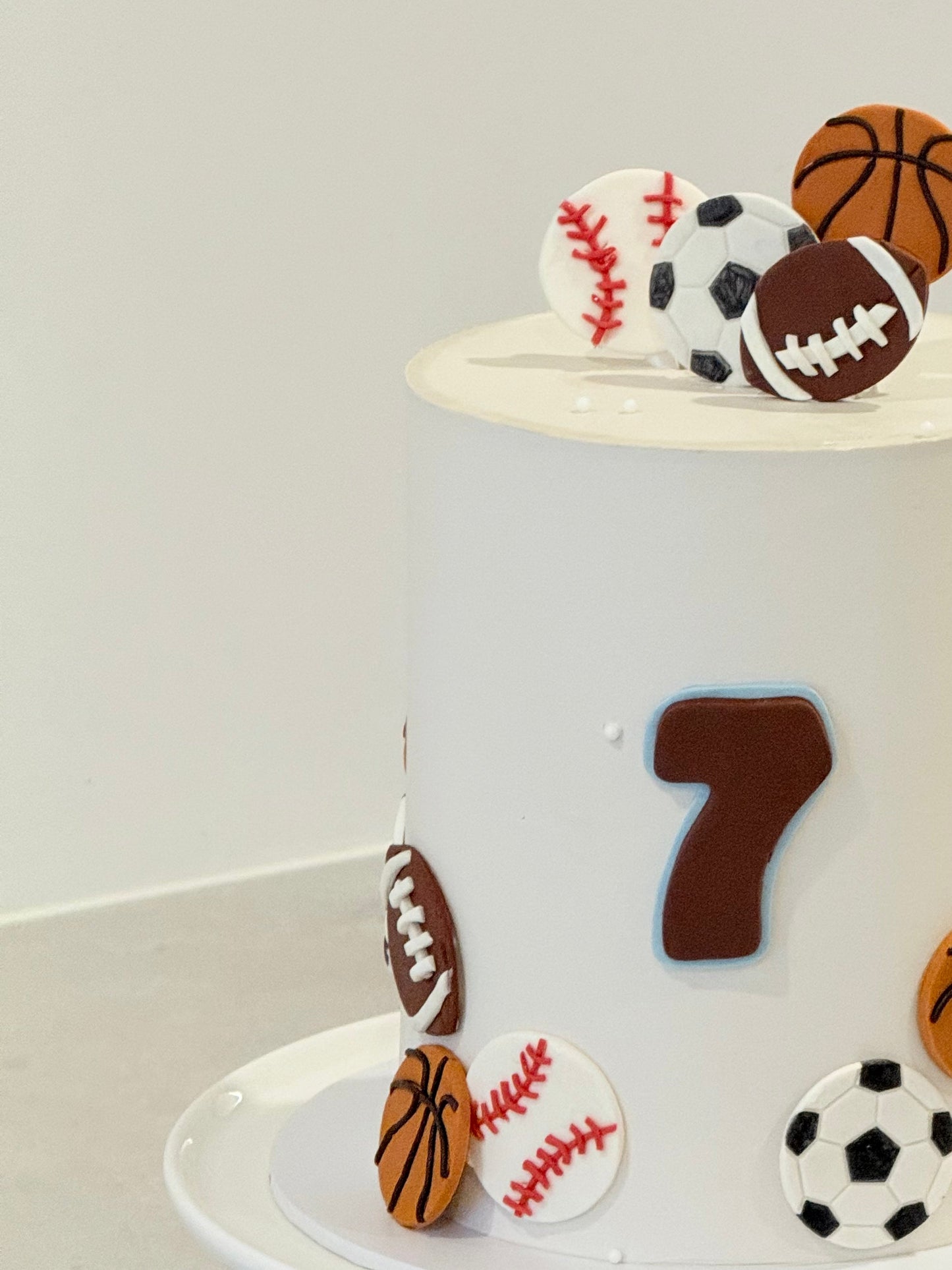 Cake with sports-themed decorations including a number 7 on a white background