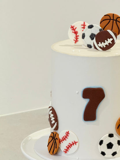 Cake with sports-themed decorations including a number 7 on a white background
