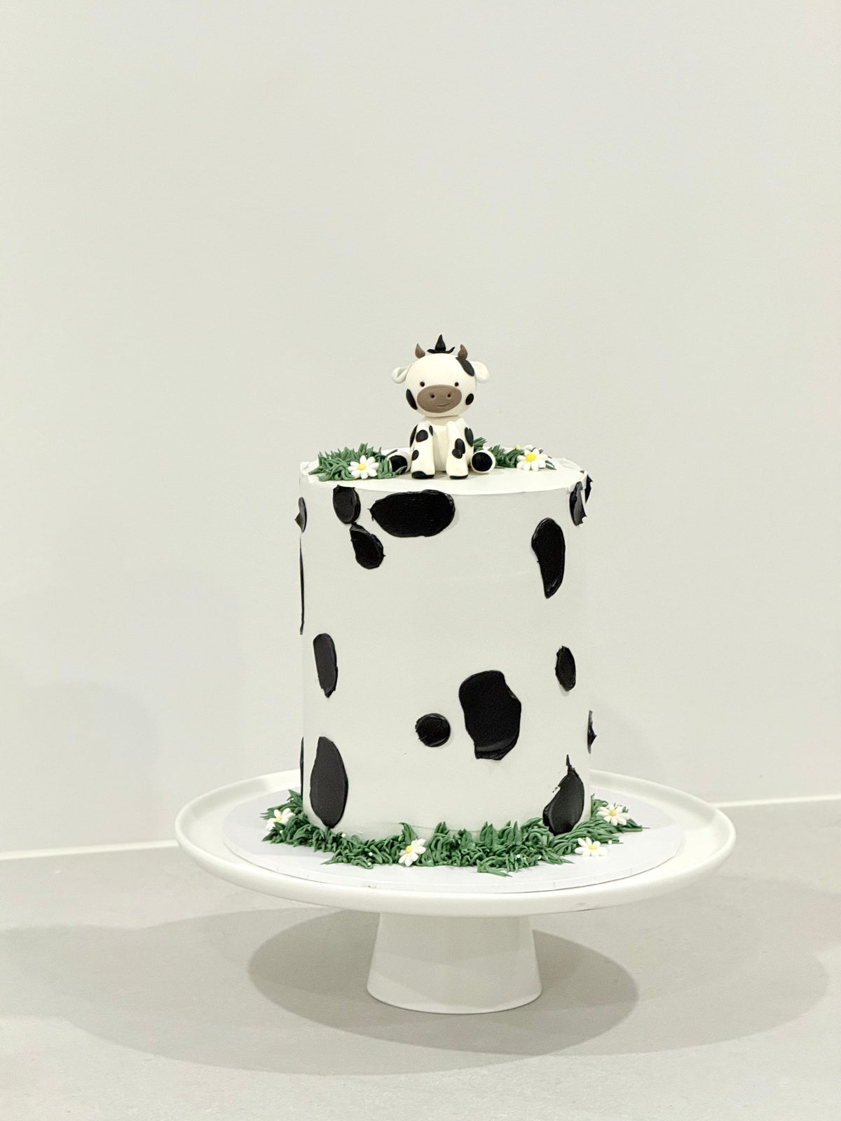 Millie cow print kids birthday cake with sculpted cow topper — Bakeology Studios Melbourne