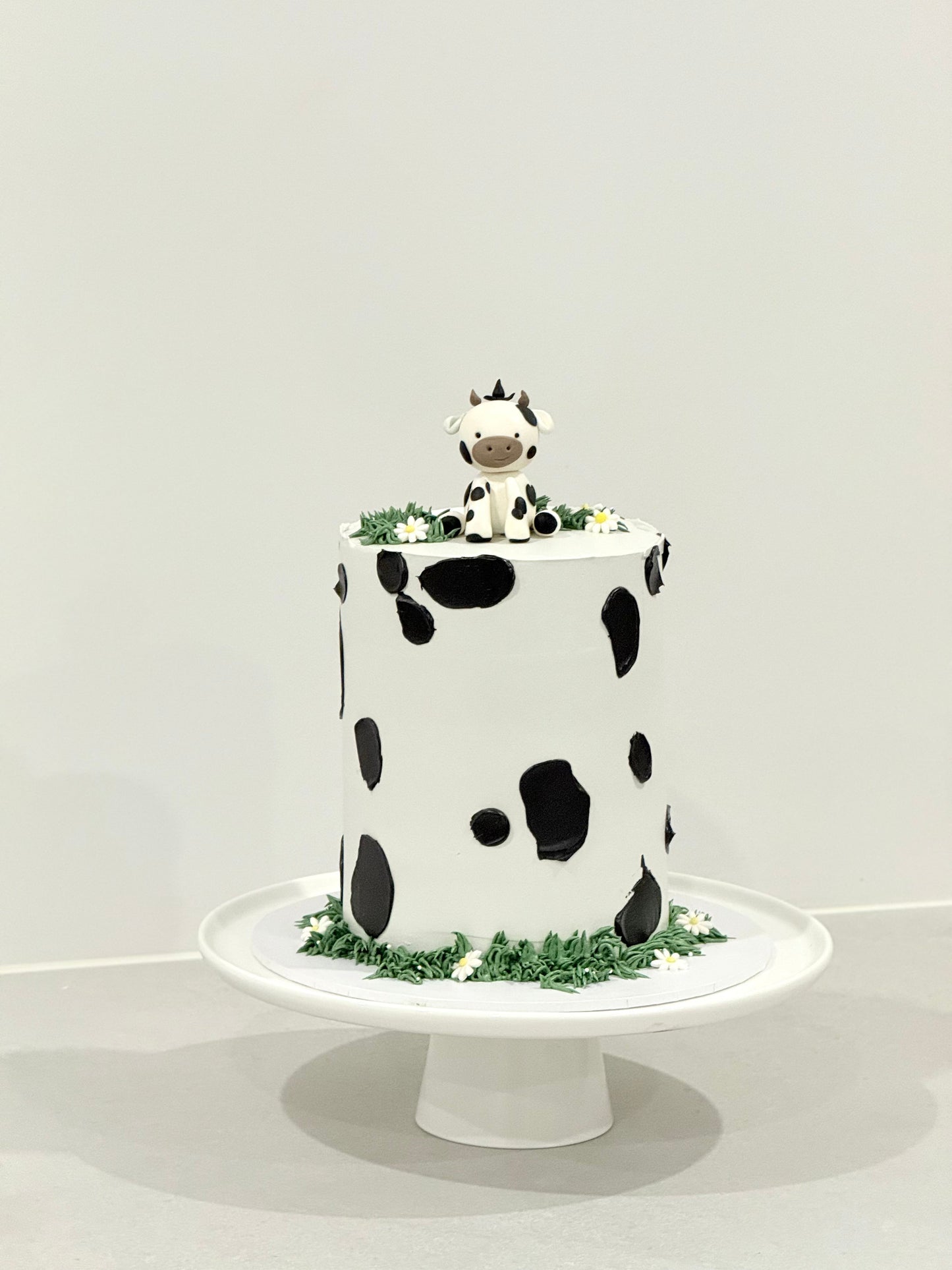 Millie cow print kids birthday cake with sculpted cow topper — Bakeology Studios Melbourne