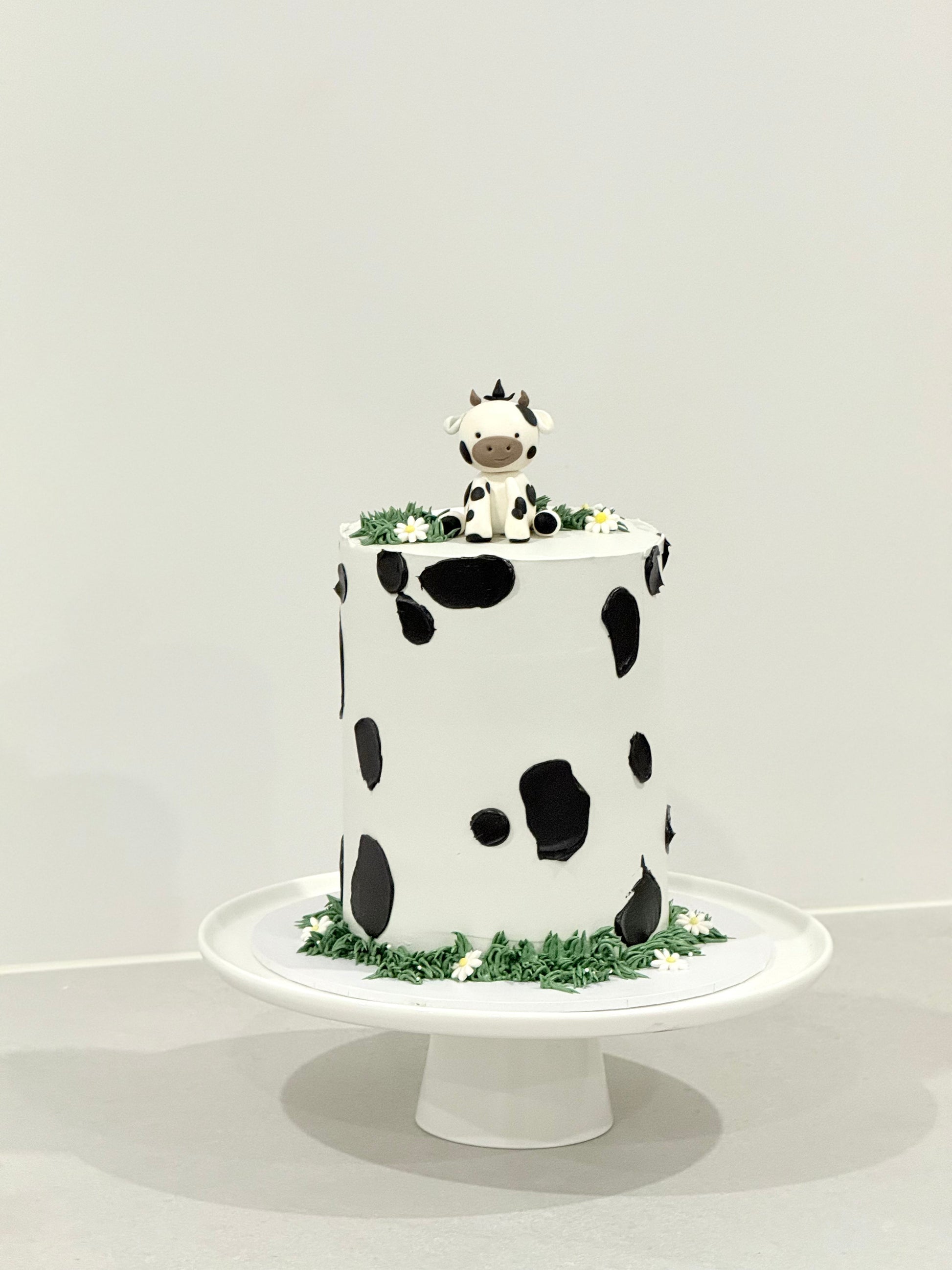 Millie cow print kids birthday cake with sculpted cow topper — Bakeology Studios Melbourne