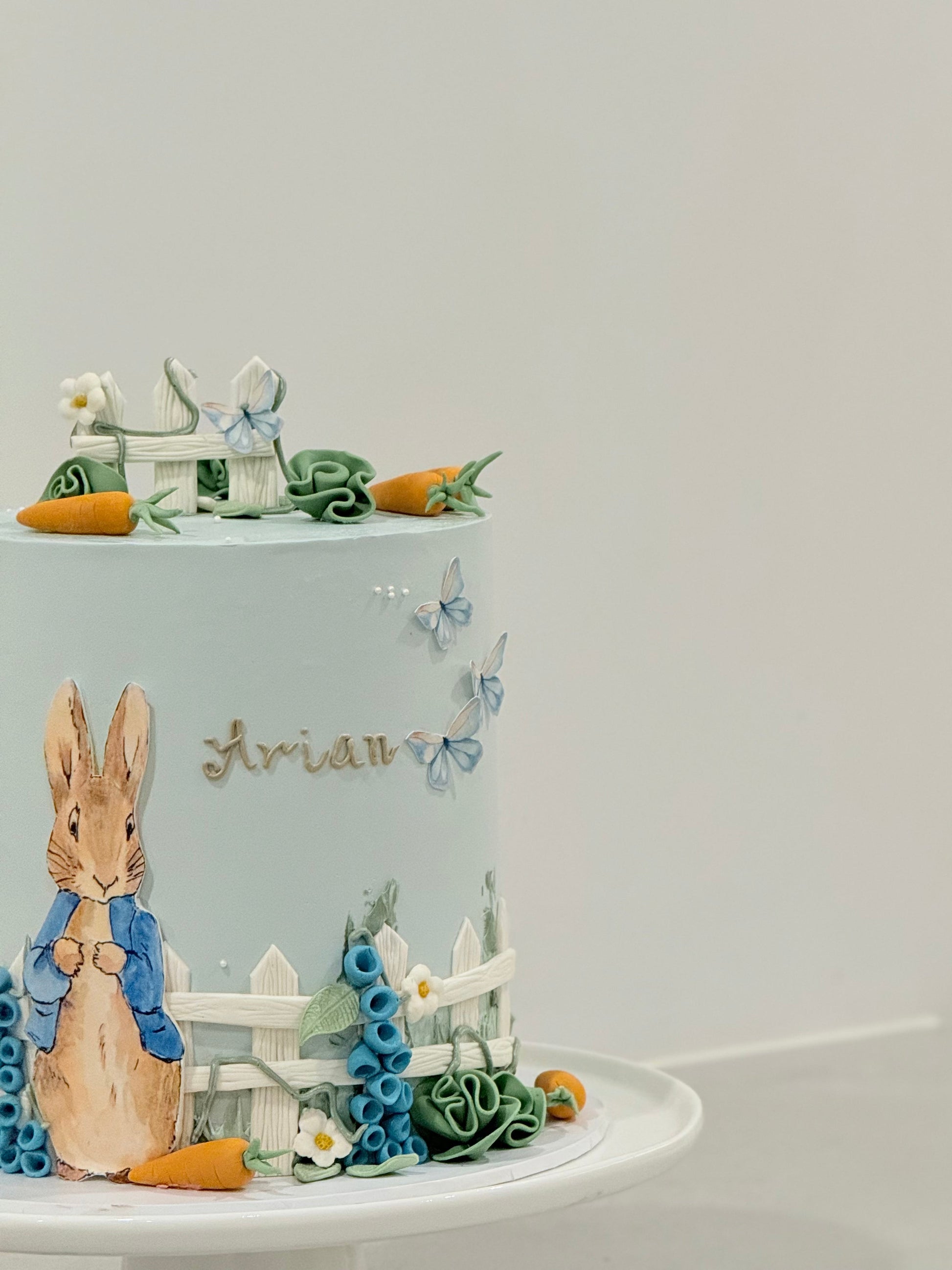Peter Rabbit birthday cake personalised name detail in gold script — handcrafted Bakeology Studios Burwood East
