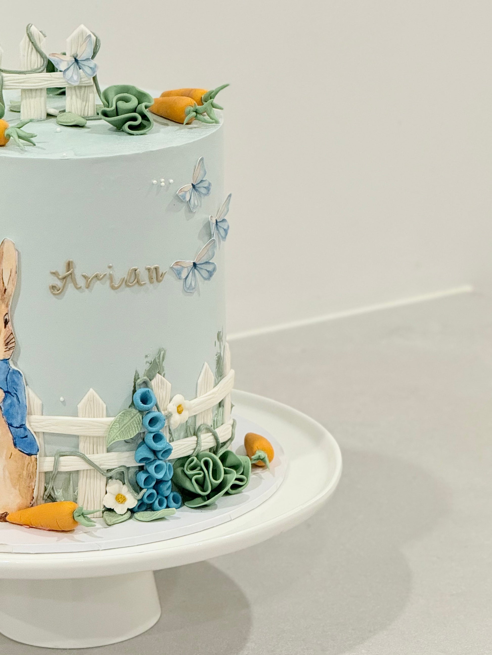 Peter Rabbit themed celebration cake handcrafted in powder blue — custom kids cake Melbourne by Bakeology Studios