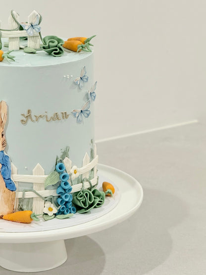 Peter Rabbit themed celebration cake handcrafted in powder blue — custom kids cake Melbourne by Bakeology Studios